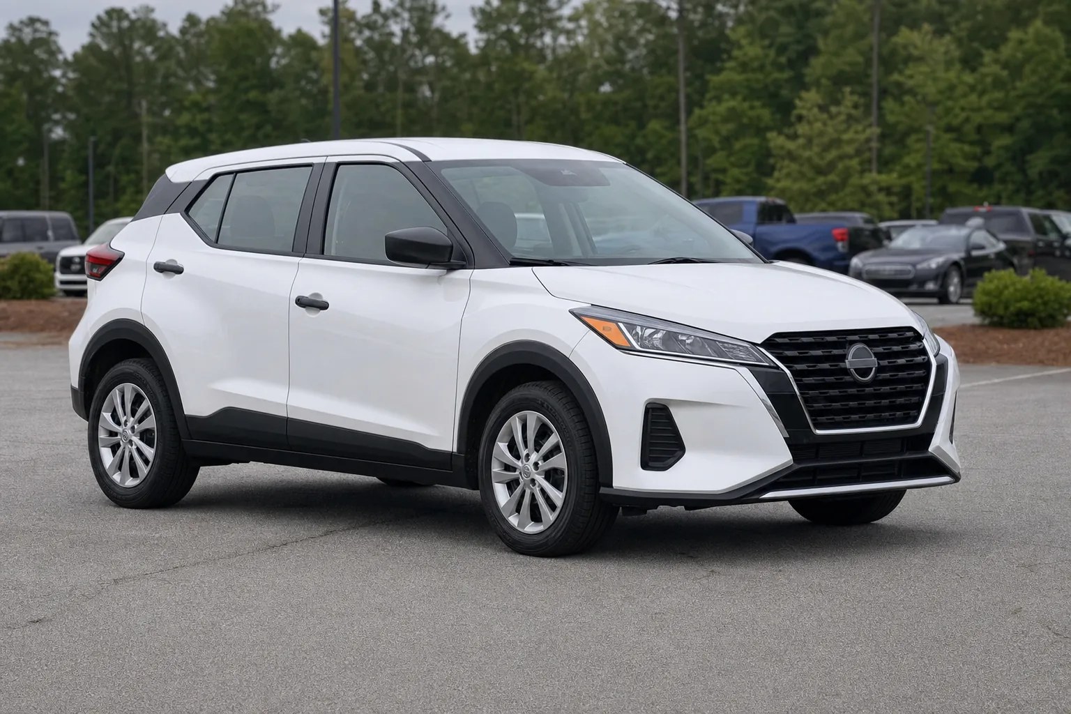 White compact rental vehicle parked outside Economy Car Rental